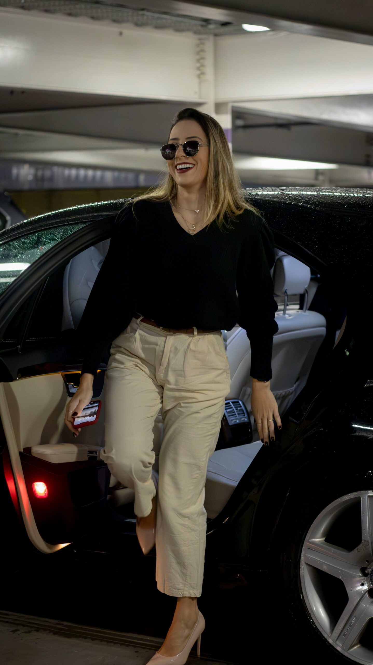 a woman walking out of a car in a parking garage